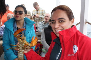 Acadia Center English student holding a Maine lobster on the Lively Lady tour in Camden.