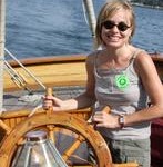 Acadia Center student at helm of schooner Olad in Camden, Maine.