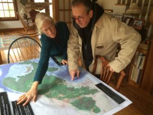 Studying wildlife migration map with ecologist Janet McMahon.